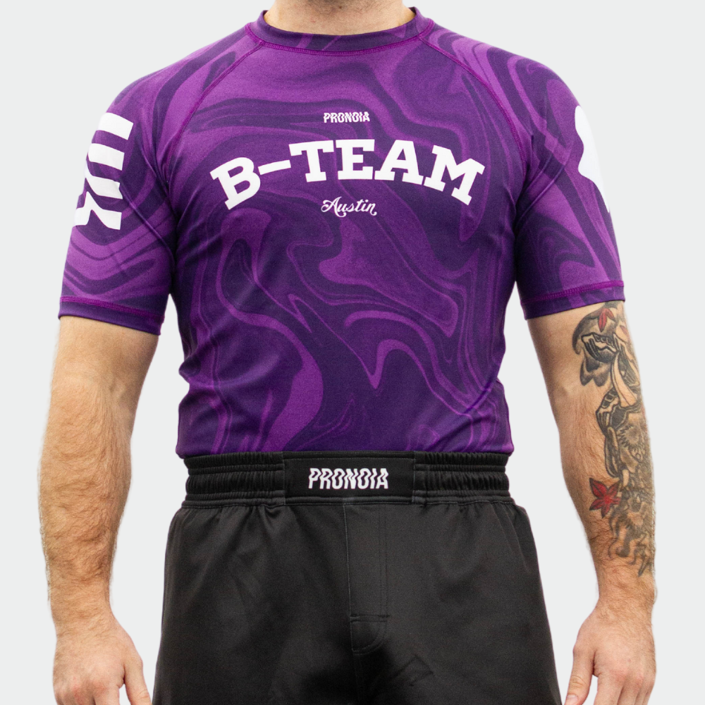 BTEAM X PRONOIA RASH GUARD PURPLE(SIZING RUNS SMALL)